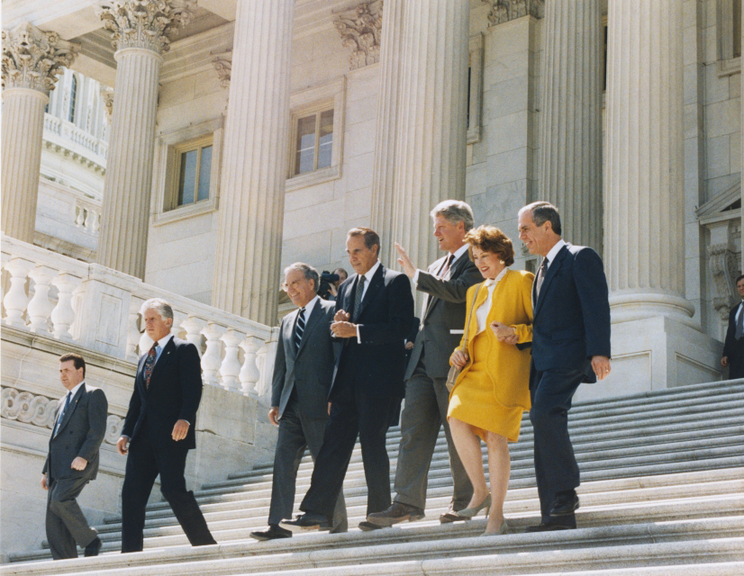 Senator George Mitchell, Dole, President Clinton, Elizabeth Dole, and Congressman Tony Coelho on the steps of the US Capitol, 1994