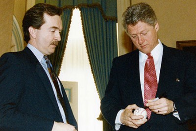 Photo of President Clinton signing a baseball for Dole's Press Secretary Walt Riker, 1993